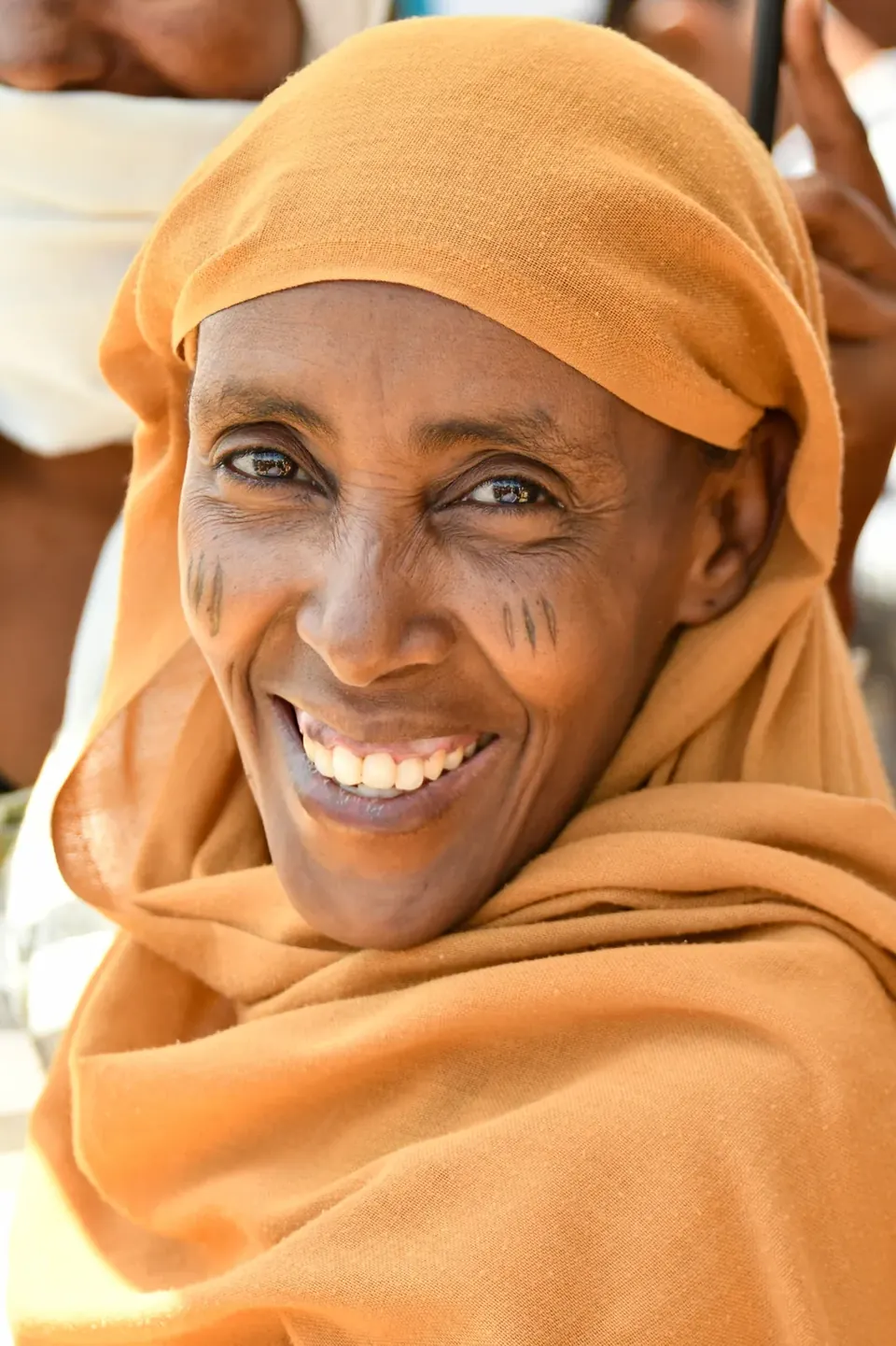 Woman smiling at an In His Name Ministries gathering