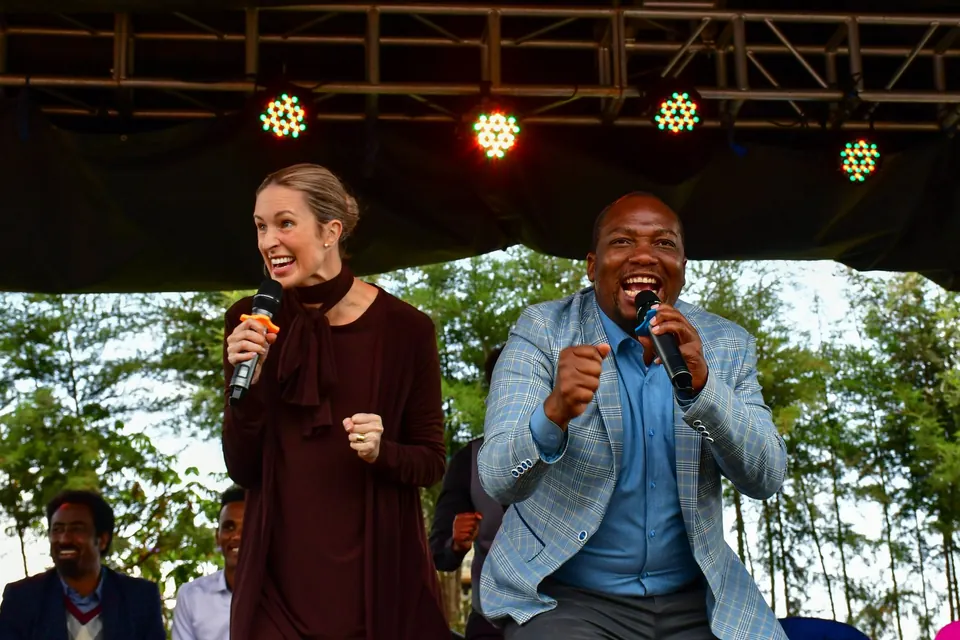 Tamryn Klintworth and a ministry partner speaking at an In His Name Ministries gathering