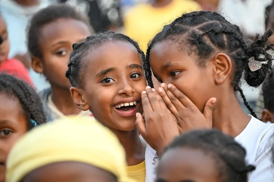 Children sharing a joyful moment in an In His Name Ministries archive photograph